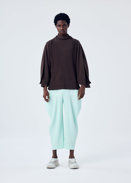 A model wears the HOMME PLISSÉ ISSEY MIYAKE KINETIC SCULPTURE top.