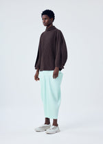 A model wears the HOMME PLISSÉ ISSEY MIYAKE KINETIC SCULPTURE top.