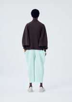 A model wears the HOMME PLISSÉ ISSEY MIYAKE KINETIC SCULPTURE top.