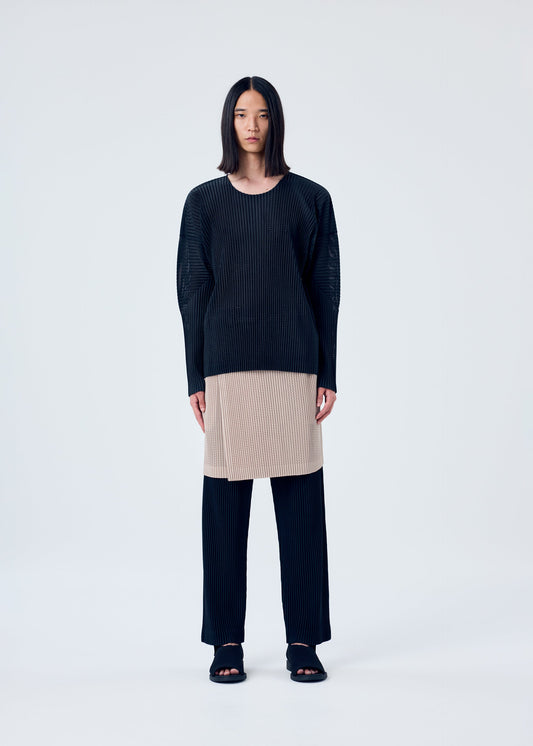 A model wears the HOMME PLISSÉ ISSEY MIYAKE LIGHT MESH top.