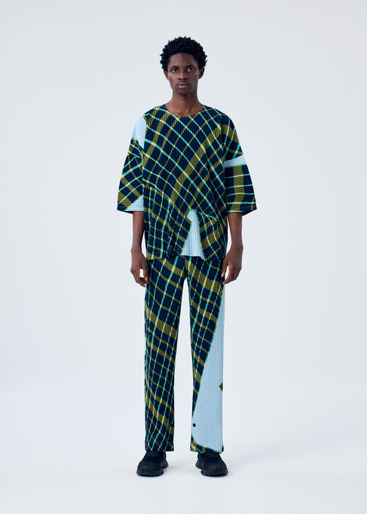 A model wears the HOMME PLISSÉ ISSEY MIYAKE WINDSWEPT PLAID top.