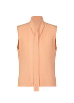 A product shot of the HOMME PLISSÉ ISSEY MIYAKE TURBINE top in pastel orange (31).