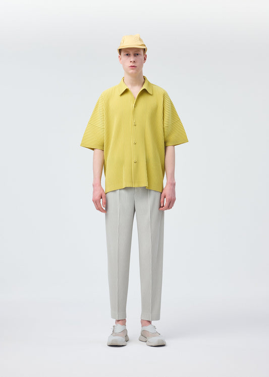 A model wears the HOMME PLISSÉ ISSEY MIYAKE STONE CAP hat.