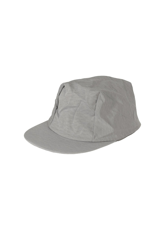 A product shot of the HOMME PLISSÉ ISSEY MIYAKE STONE CAP hat in silver grey.