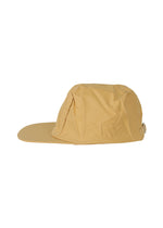 A detail shot of the HOMME PLISSÉ ISSEY MIYAKE STONE CAP hat.