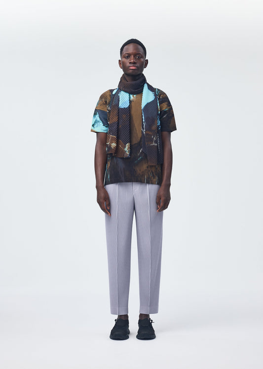A model wears the HOMME PLISSÉ ISSEY MIYAKE AGATE SCARF stole.
