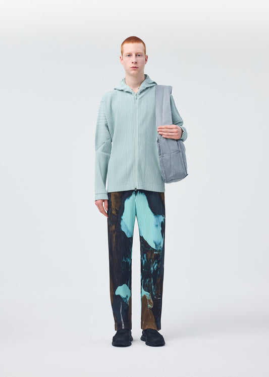 A model wears the HOMME PLISSÉ ISSEY MIYAKE STONE BAG bag.