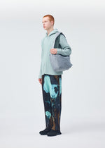 A model wears the HOMME PLISSÉ ISSEY MIYAKE STONE BAG bag.