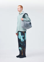 A model wears the HOMME PLISSÉ ISSEY MIYAKE STONE BAG bag.