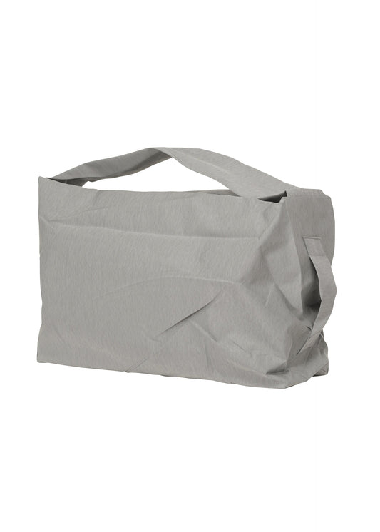 A product shot of the HOMME PLISSÉ ISSEY MIYAKE STONE BAG bag in silver grey (90).
