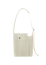 A product shot of the HOMME PLISSÉ ISSEY MIYAKE UTILITY bag in limestone white (04).