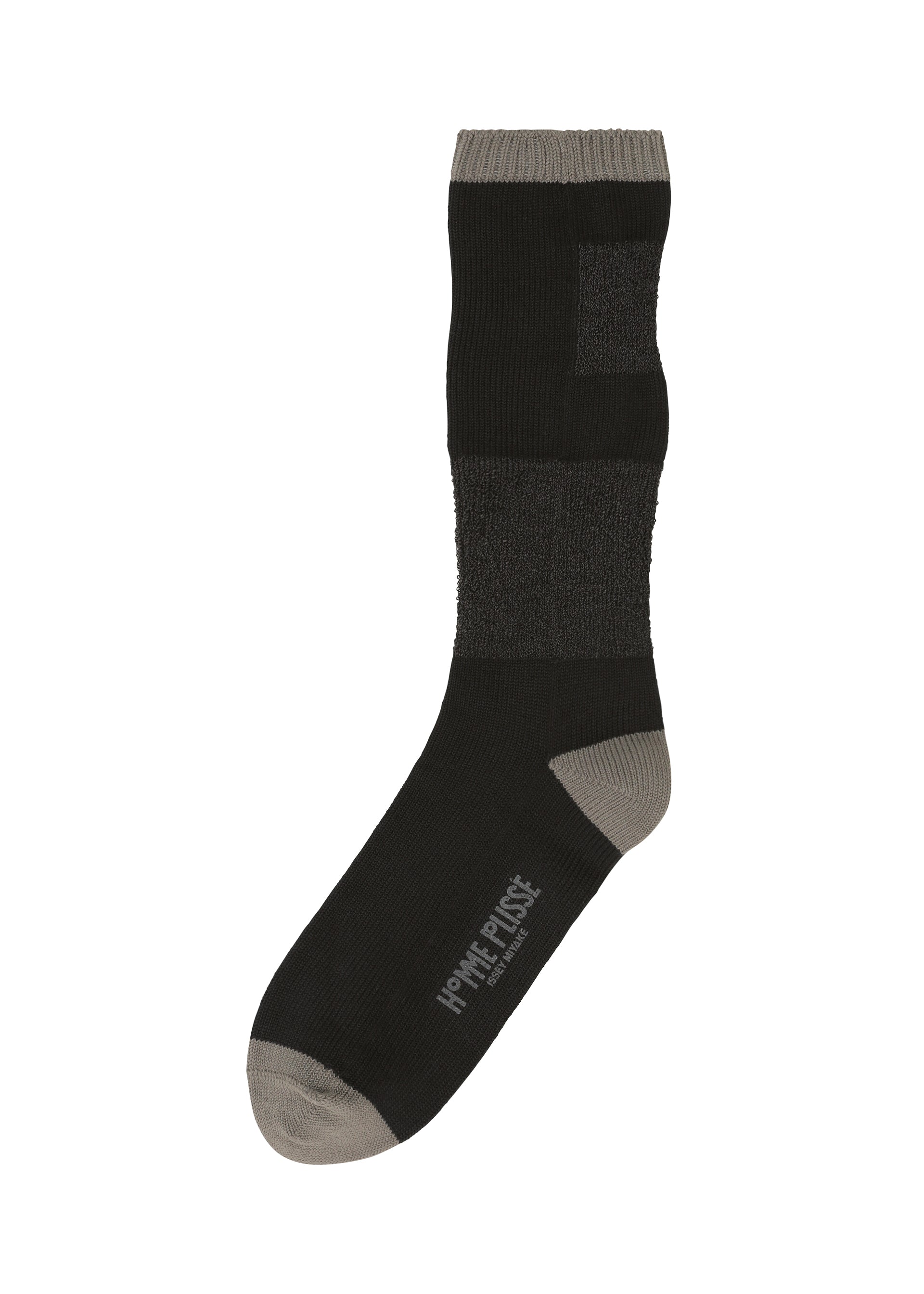 A product shot of the HOMME PLISSÉ ISSEY MIYAKE SCULPTURAL SOCKS socks in black (15).