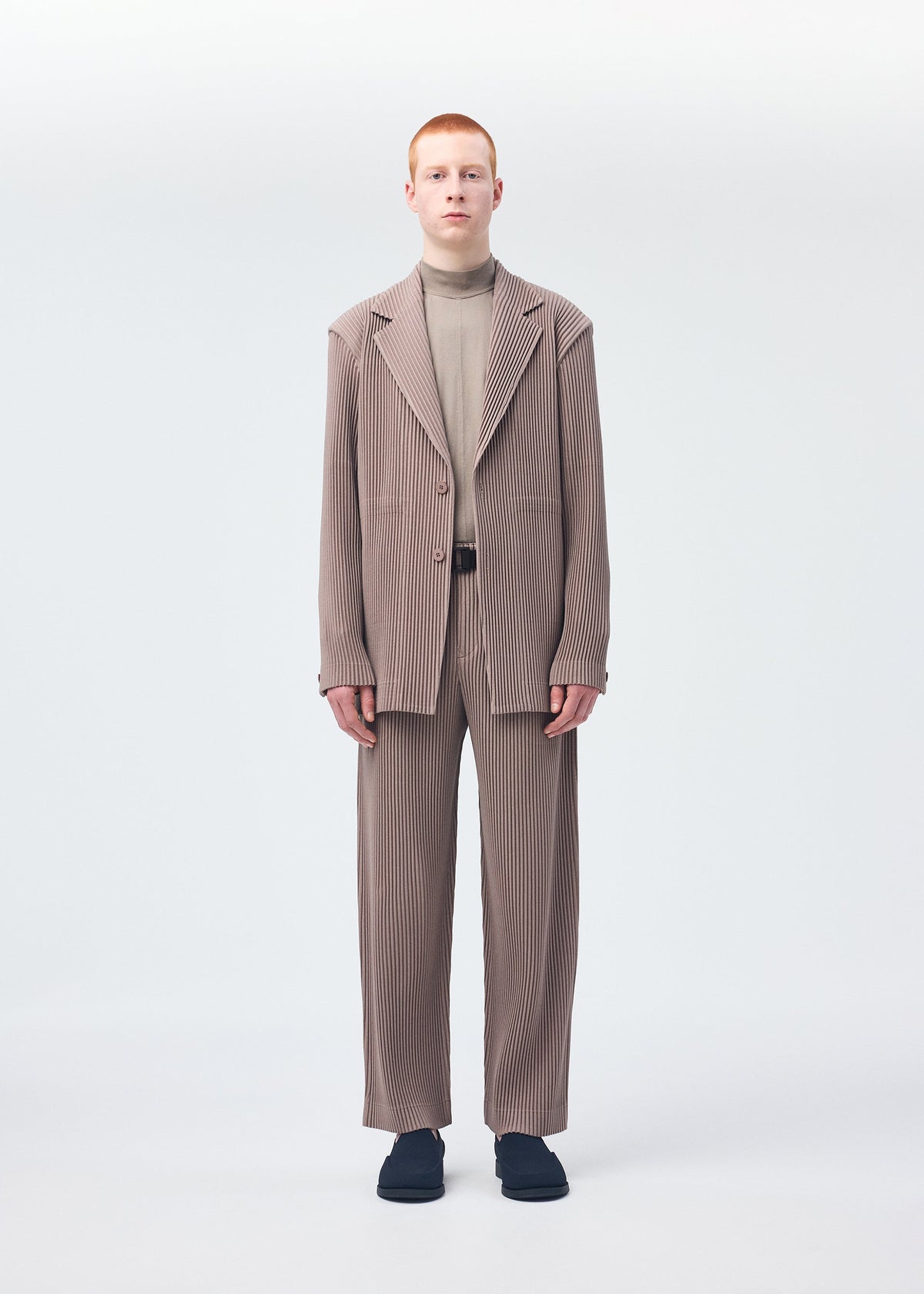 A model wears the HOMME PLISSÉ ISSEY MIYAKE KERSEY PLEATS jacket.