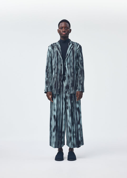 A model wears the HOMME PLISSÉ ISSEY MIYAKE BRUSHSTROKE STRIPE jacket.