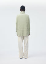 A model wears the HOMME PLISSÉ ISSEY MIYAKE QUARRY PANTS trousers.