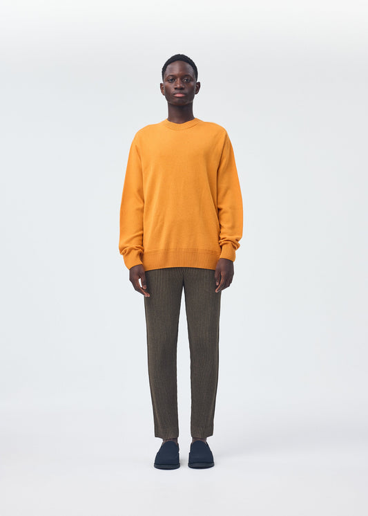 A model wears the HOMME PLISSÉ ISSEY MIYAKE WOOL LIKE LIGHT trousers.