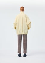 A model wears the HOMME PLISSÉ ISSEY MIYAKE PADDED RIM SHIRT shirt.