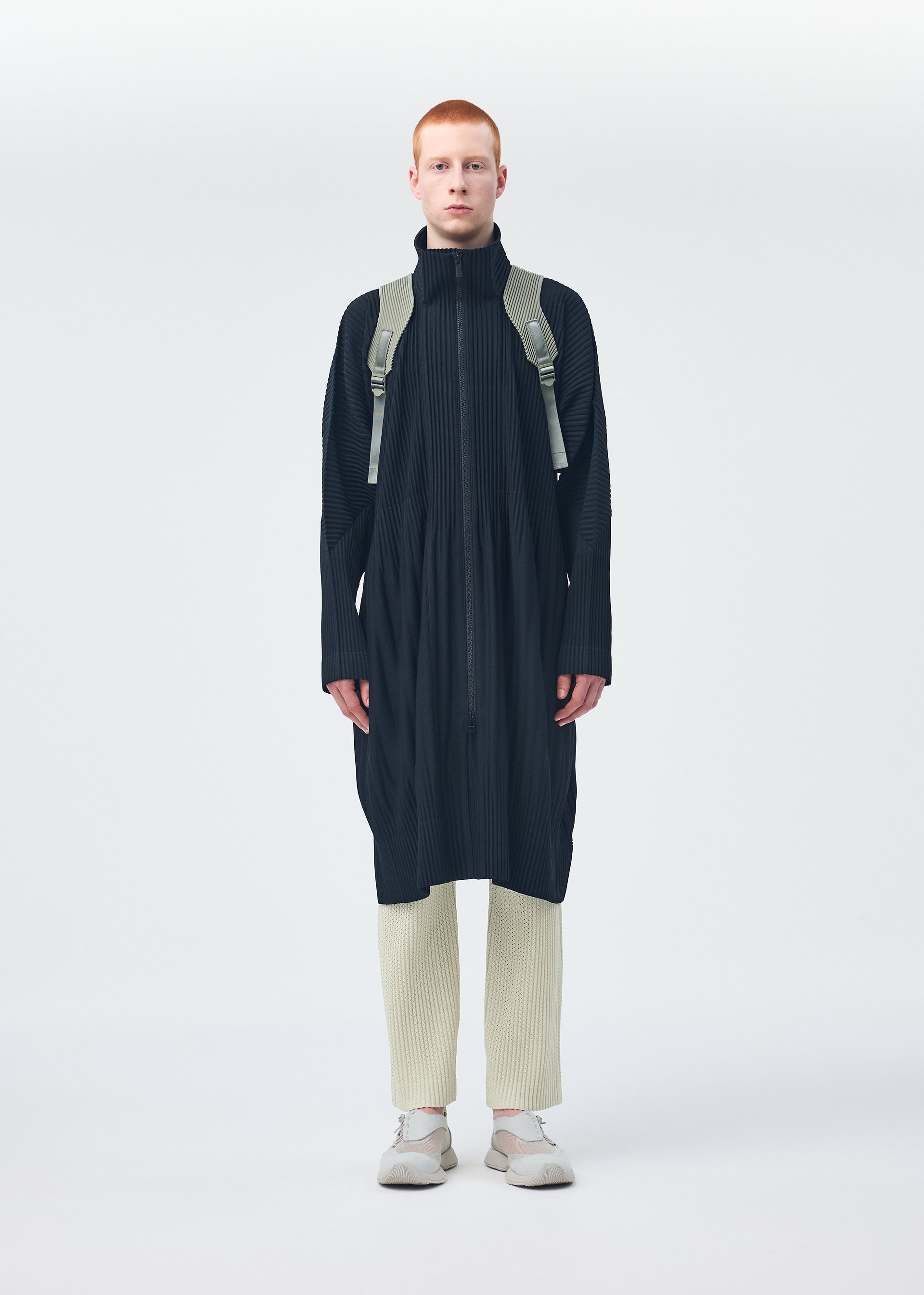 A model wears the HOMME PLISSÉ ISSEY MIYAKE MONTHLY COLORS NOVEMBER coat.