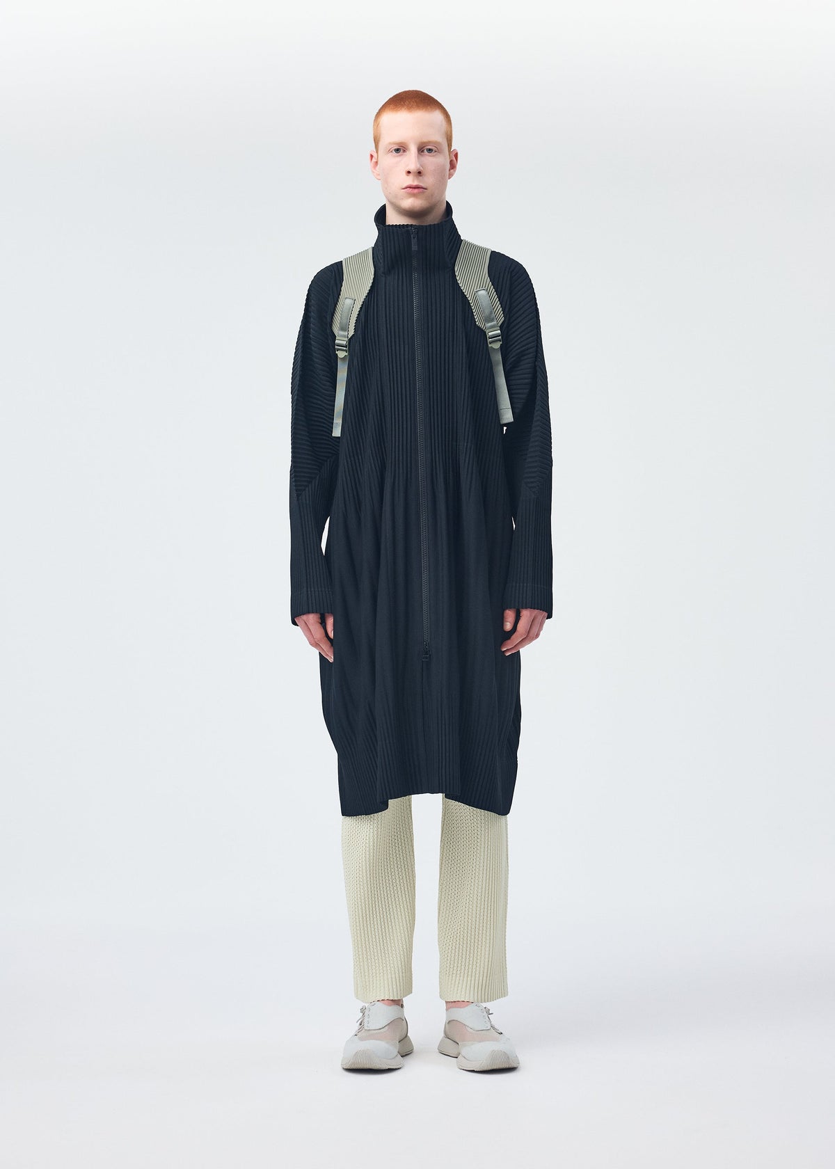 A model wears the HOMME PLISSÉ ISSEY MIYAKE MONTHLY COLORS NOVEMBER coat.
