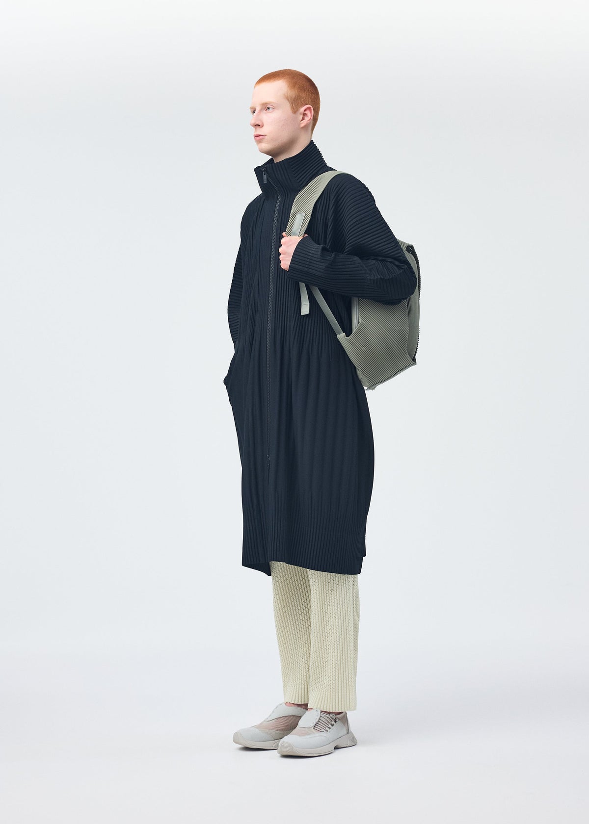 A model wears the HOMME PLISSÉ ISSEY MIYAKE MONTHLY COLORS NOVEMBER coat.