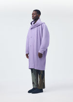 A model wears the HOMME PLISSÉ ISSEY MIYAKE MONTHLY COLORS DECEMBER clothing.