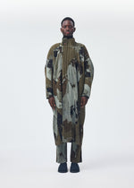 A model wears the HOMME PLISSÉ ISSEY MIYAKE PAINTED STONE clothing.
