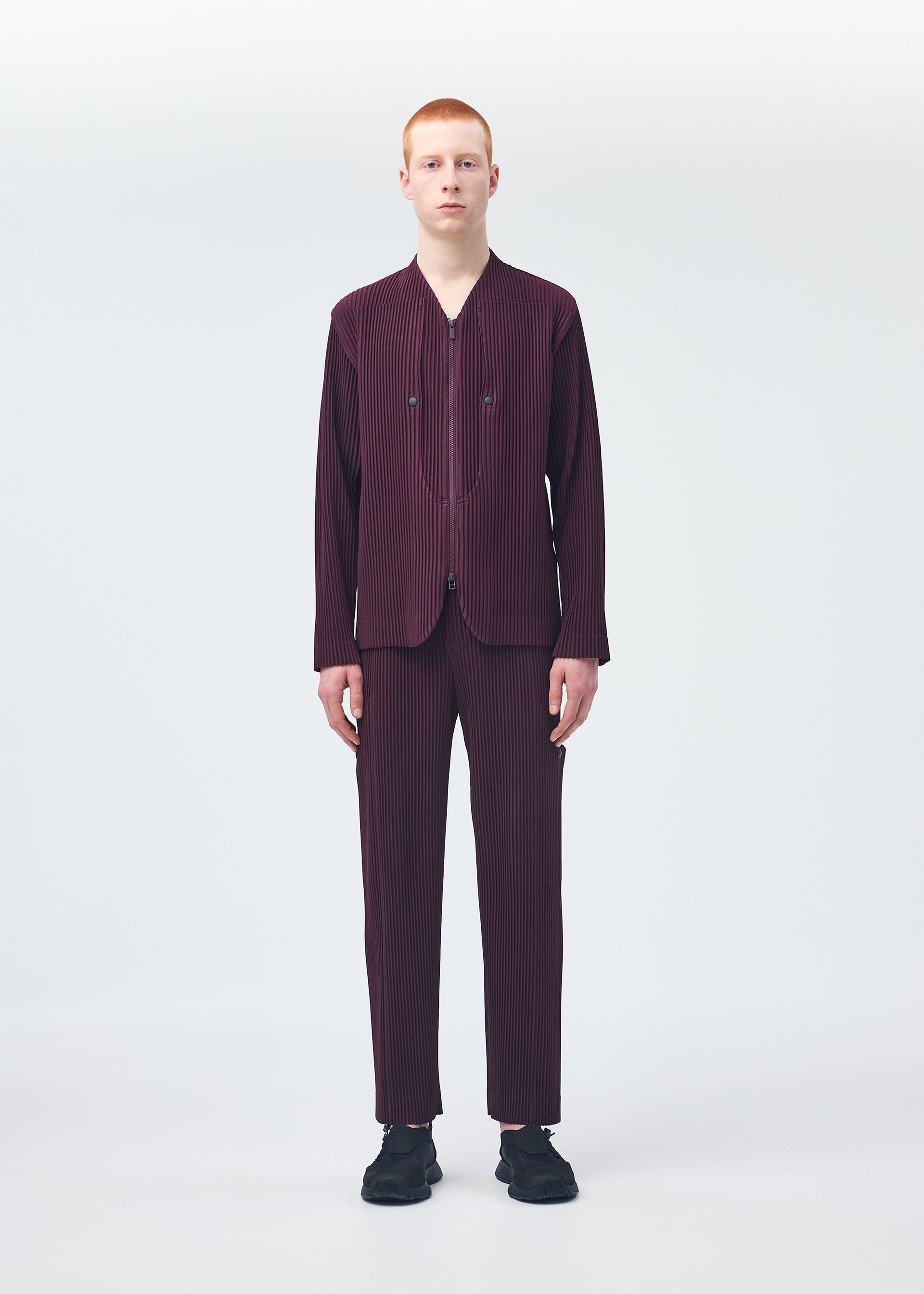 A model wears the HOMME PLISSÉ ISSEY MIYAKE QUARRY jacket.