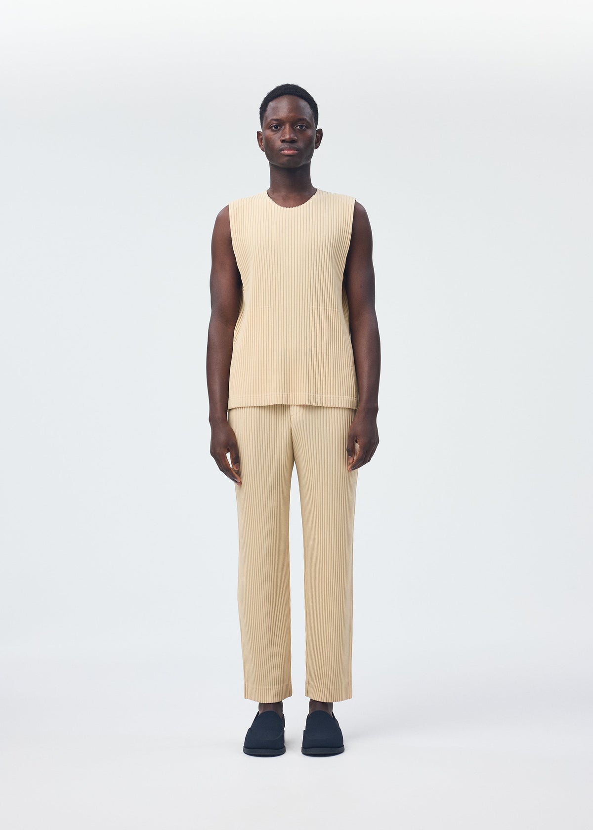 A model wears the HOMME PLISSÉ ISSEY MIYAKE TAILORED PLEATS 2 clothing.