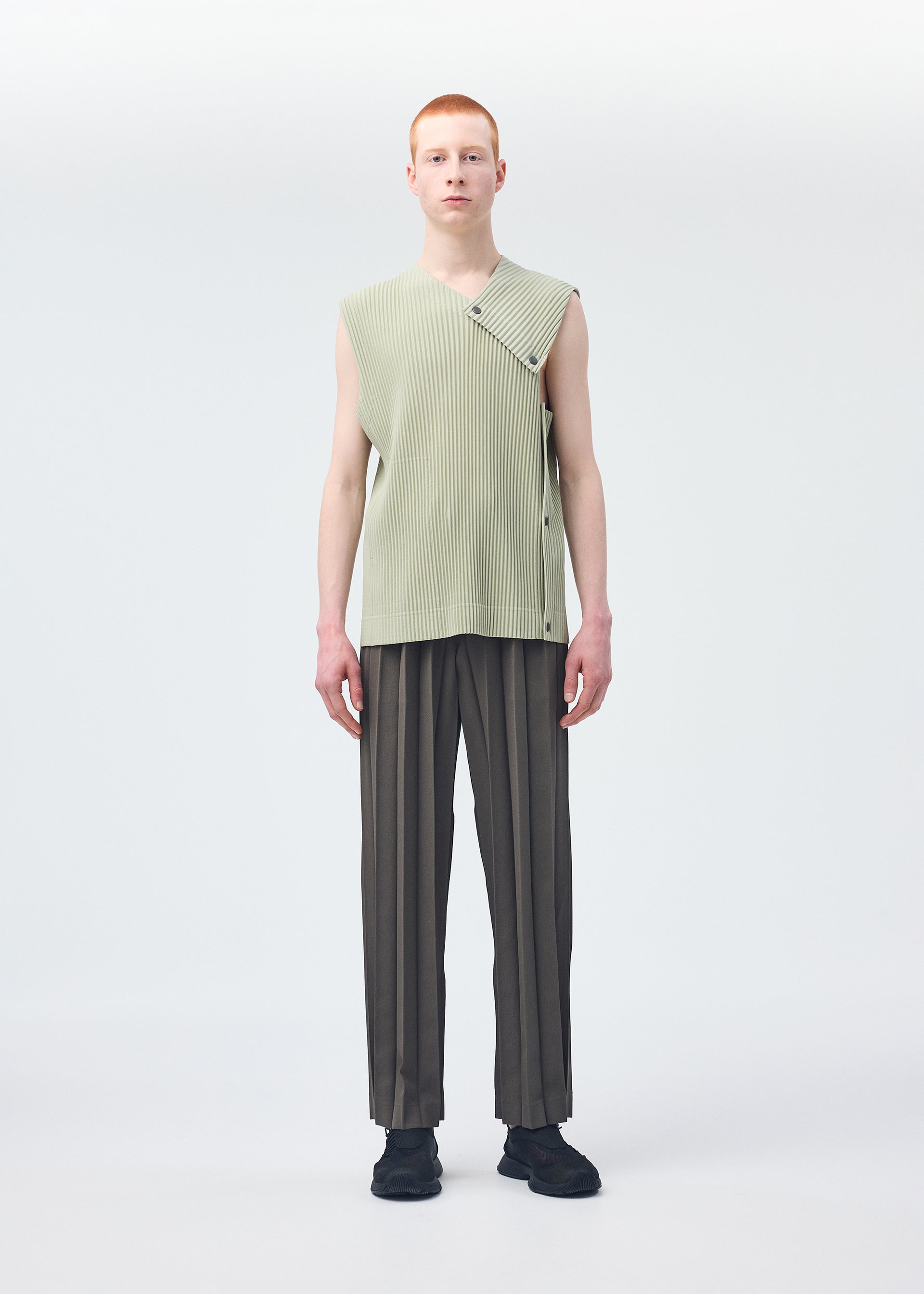 A model wears the HOMME PLISSÉ ISSEY MIYAKE STONE CLOUD vest.