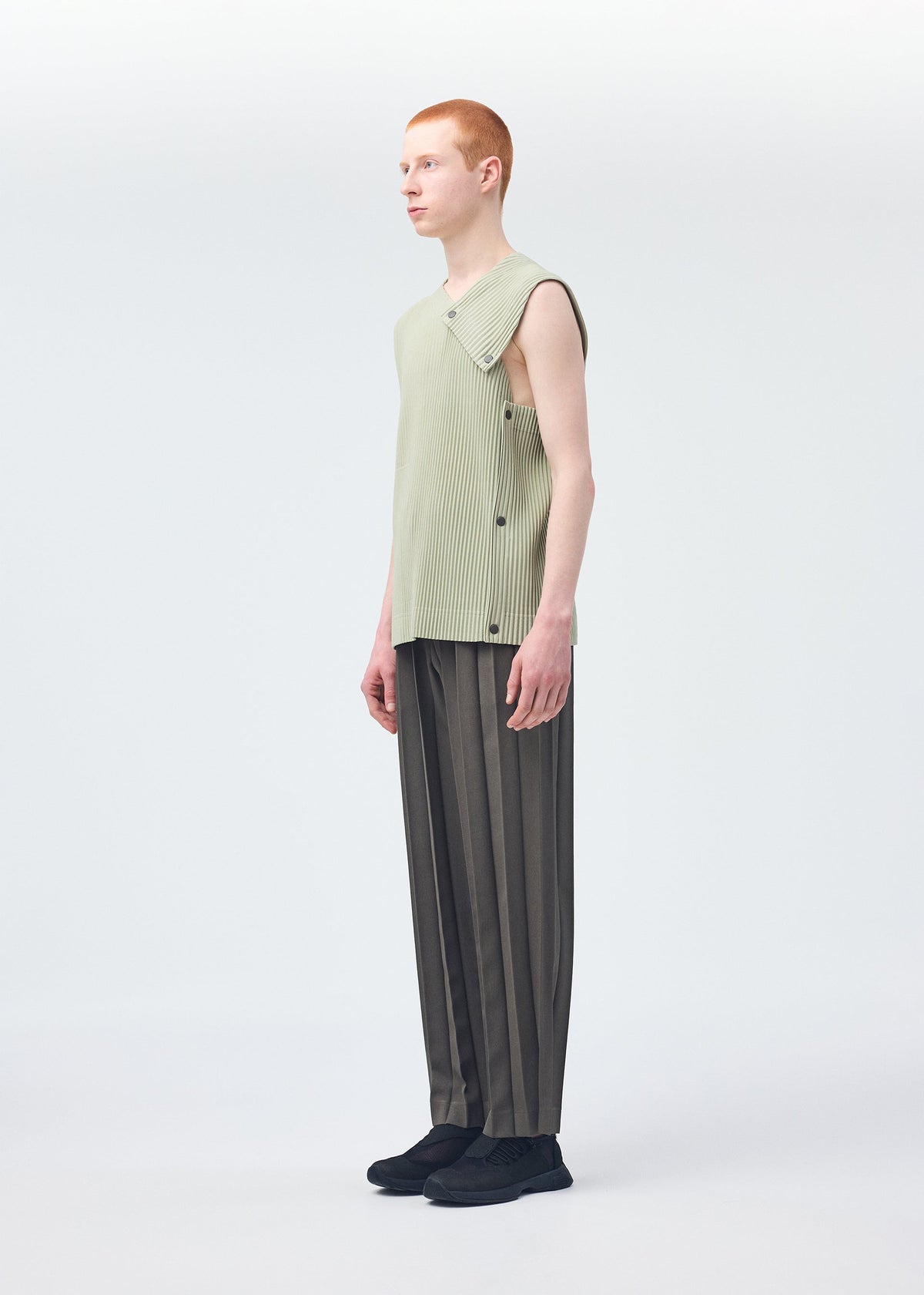 A model wears the HOMME PLISSÉ ISSEY MIYAKE STONE CLOUD vest.