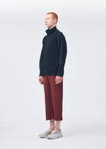A model wears the HOMME PLISSÉ ISSEY MIYAKE MONTHLY COLORS AUGUST trousers.