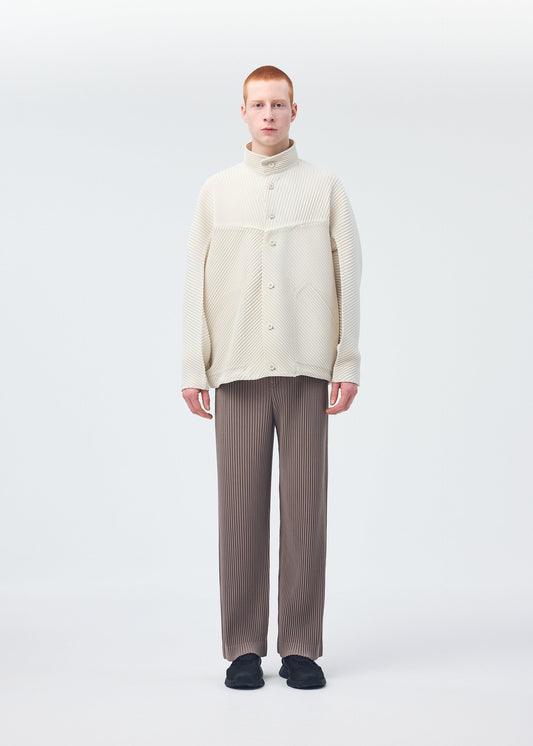 A model wears the HOMME PLISSÉ ISSEY MIYAKE MONTHLY COLORS SEPTEMBER trousers.