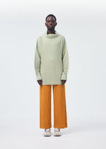 A model wears the HOMME PLISSÉ ISSEY MIYAKE MONTHLY COLORS OCTOBER trousers.