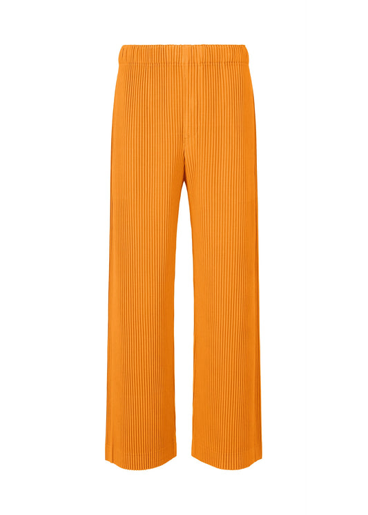 A product shot of the HOMME PLISSÉ ISSEY MIYAKE MONTHLY COLORS OCTOBER trousers in orpiment orange (33).