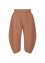 A product shot of the HOMME PLISSÉ ISSEY MIYAKE PLEATS BOTTOMS 1 trousers in vanadinite red (26).