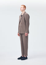 A model wears the HOMME PLISSÉ ISSEY MIYAKE TAILORED PLEATS 1 trousers.