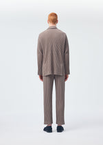 A model wears the HOMME PLISSÉ ISSEY MIYAKE TAILORED PLEATS 1 trousers.