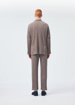 A model wears the HOMME PLISSÉ ISSEY MIYAKE TAILORED PLEATS 1 trousers.