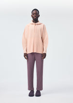 A model wears the HOMME PLISSÉ ISSEY MIYAKE COLOR PLEATS trousers.