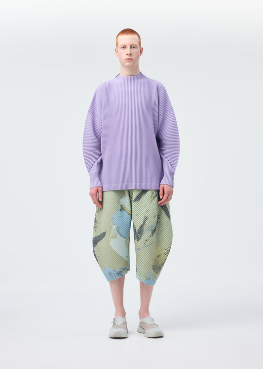A model wears the HOMME PLISSÉ ISSEY MIYAKE PAINTED STONE clothing.