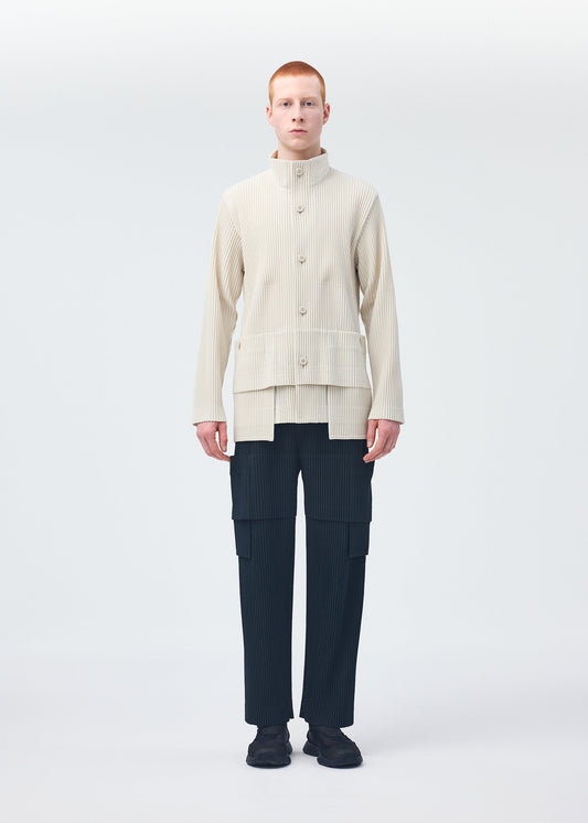 A model wears the HOMME PLISSÉ ISSEY MIYAKE MULTI POCKET trousers.