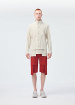 A model wears the HOMME PLISSÉ ISSEY MIYAKE MULTI POCKET trousers.