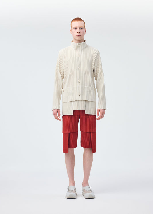 A model wears the HOMME PLISSÉ ISSEY MIYAKE MULTI POCKET trousers.