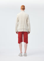A model wears the HOMME PLISSÉ ISSEY MIYAKE MULTI POCKET trousers.
