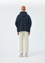 A model wears the HOMME PLISSÉ ISSEY MIYAKE WICKERWORK MESH trousers.