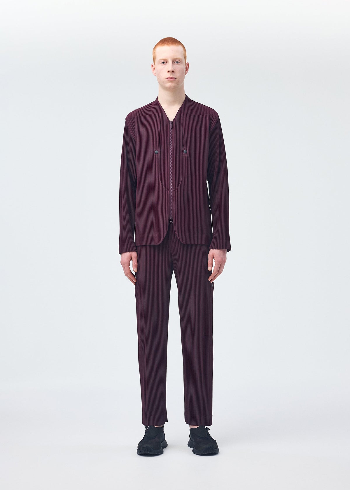 A model wears the HOMME PLISSÉ ISSEY MIYAKE QUARRY trousers.