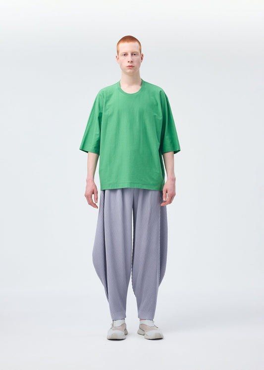 A model wears the HOMME PLISSÉ ISSEY MIYAKE ANGULAR STONE trousers.