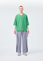 A model wears the HOMME PLISSÉ ISSEY MIYAKE ANGULAR STONE trousers.