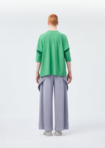 A model wears the HOMME PLISSÉ ISSEY MIYAKE ANGULAR STONE trousers.