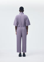 A model wears the HOMME PLISSÉ ISSEY MIYAKE PLEATS BOTTOMS 1 jumpsuit.